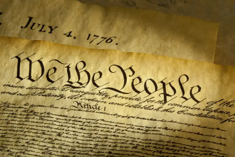 A close-up photo of the U.S. Constitution with the words "We the People".