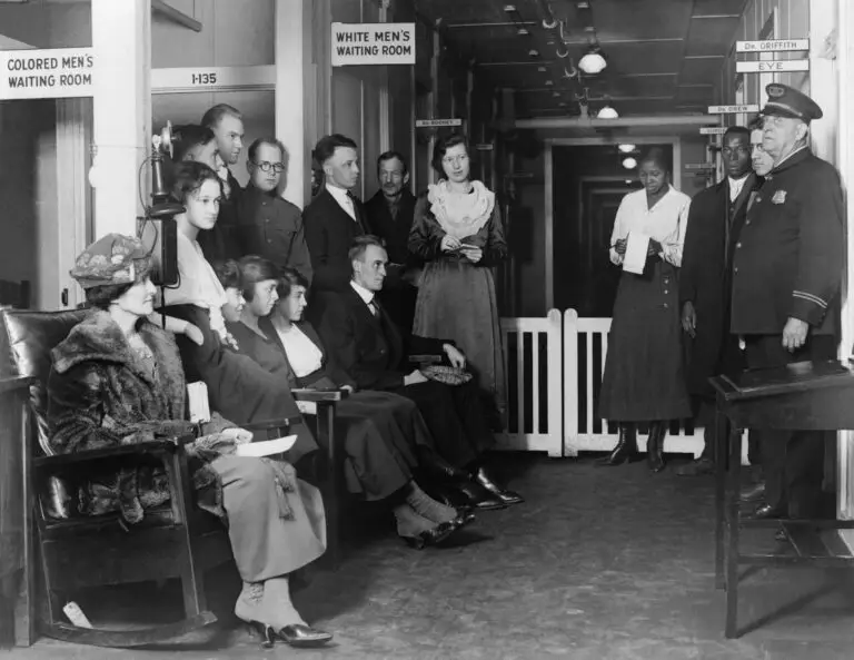 Black and white photo depicting segregated waiting rooms under Jim Crow laws.