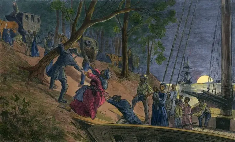 An 1856 colored engraving depicting a group of fifteen fugitive slaves arriving at night by boat on the banks of the Schuylkill River in Philadelphia. Men, women, and children are depicted disembarking onto the shore, where they are met by other figures. In the background, the silhouette of a ship and a twilight sky with the setting sun are visible.