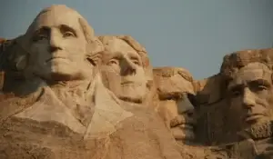 The Mount Rushmore National Memorial with sculptures of the faces of four American presidents from U.S history.